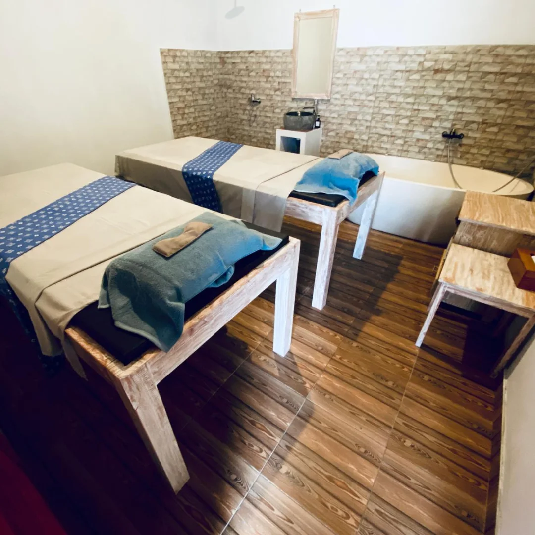 Couples treatment room with twin beds and tub